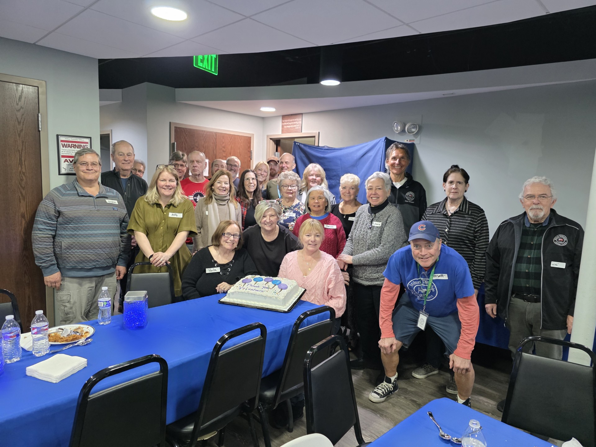 Food Pantry Volunteers around cake smiling